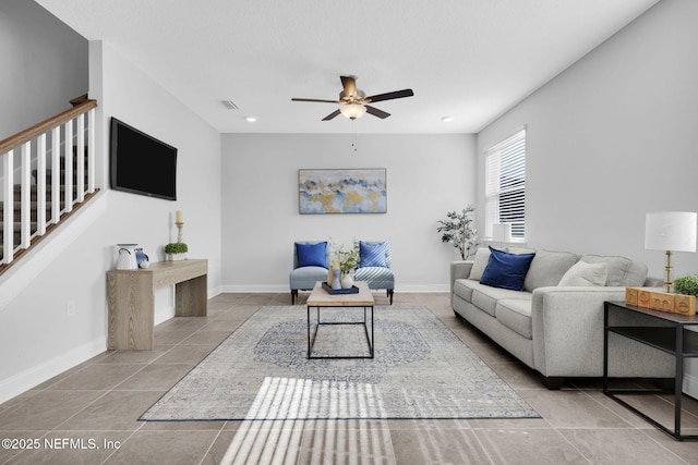 living room with light tile patterned floors and ceiling fan