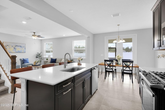 kitchen with pendant lighting, sink, a breakfast bar area, a kitchen island with sink, and stainless steel appliances