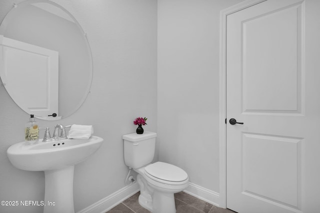 bathroom with tile patterned flooring and toilet