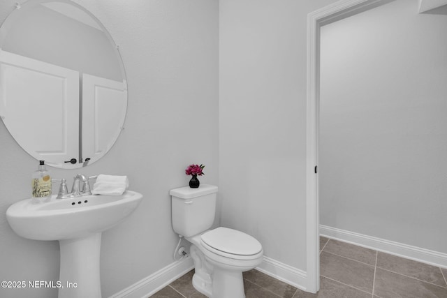 bathroom featuring tile patterned floors and toilet