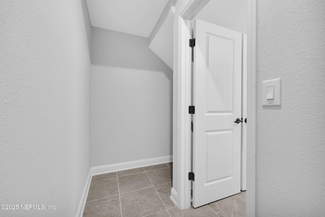 walk in closet with light tile patterned flooring