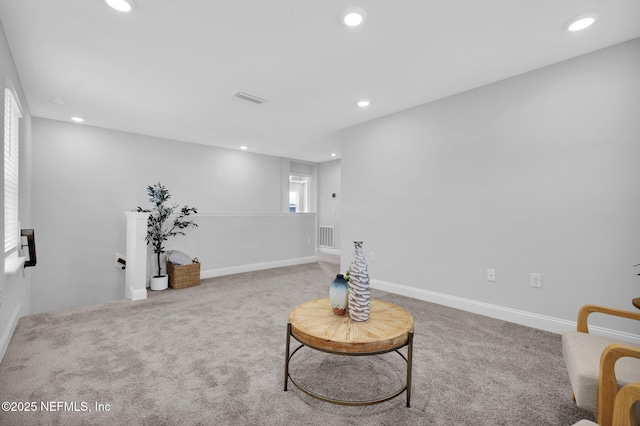 sitting room featuring carpet flooring