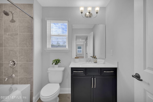 full bathroom with a healthy amount of sunlight, vanity, tiled shower / bath, and toilet