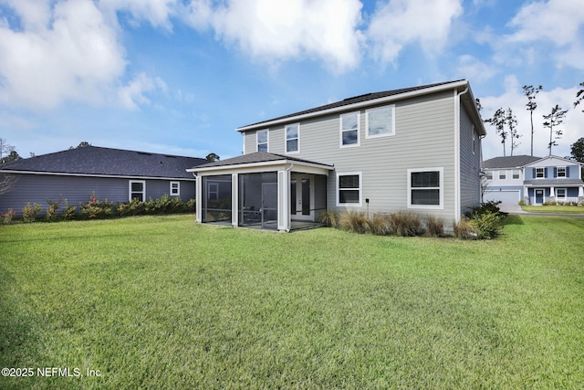 back of house featuring a sunroom and a yard