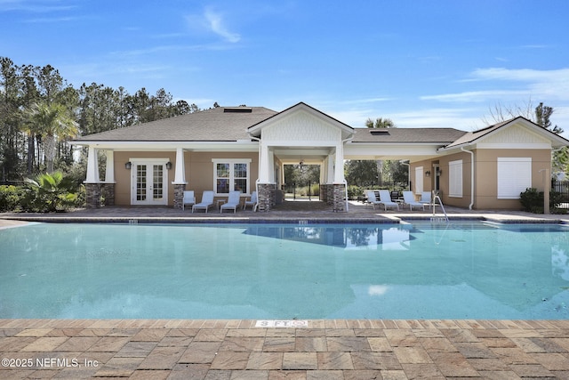 view of swimming pool with a patio area and french doors