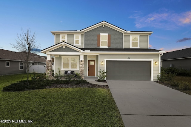 view of front of house featuring a garage and a yard