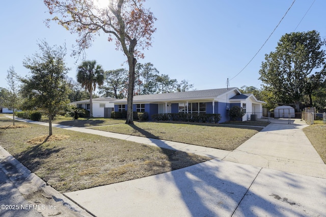 ranch-style home featuring a front yard