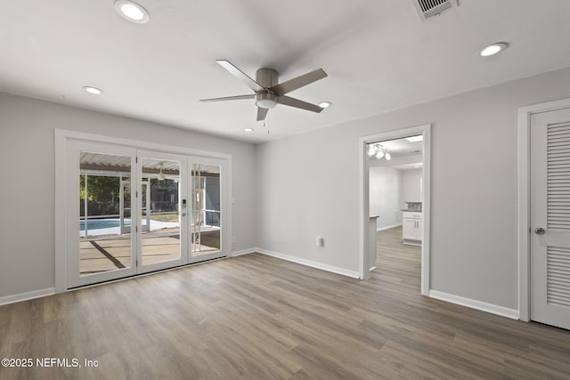 empty room with ceiling fan and hardwood / wood-style floors