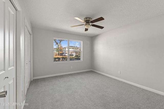 unfurnished bedroom featuring a textured ceiling, ceiling fan, and carpet flooring