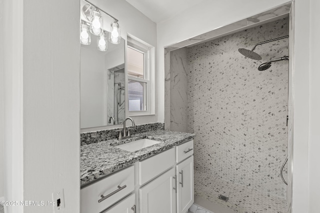 bathroom featuring vanity and a tile shower