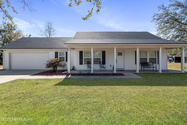 view of front of property featuring a garage, a front lawn, and covered porch