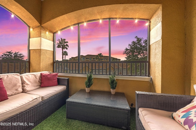 patio terrace at dusk featuring an outdoor hangout area