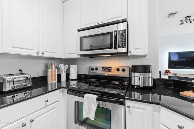 kitchen featuring white cabinetry and appliances with stainless steel finishes