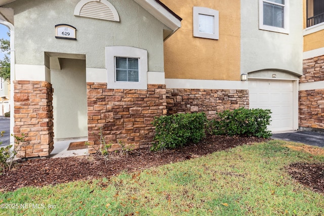 view of exterior entry featuring a garage