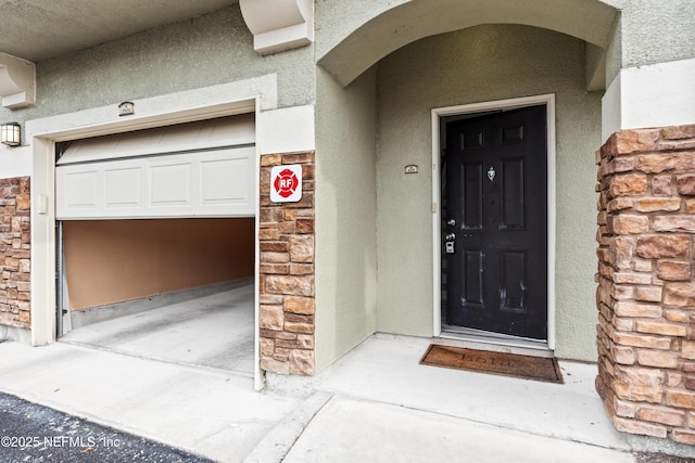 view of exterior entry with a garage