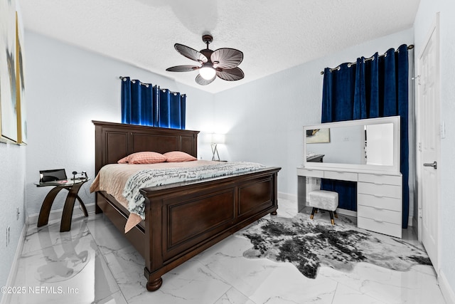 bedroom with a textured ceiling and ceiling fan