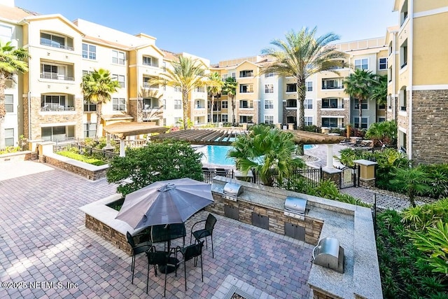 exterior space featuring a patio area and an outdoor kitchen