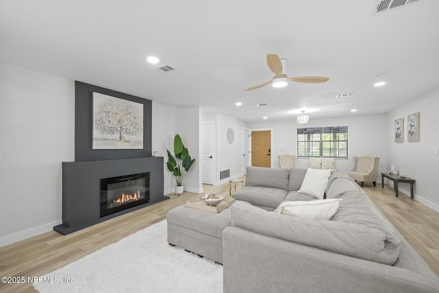 living room featuring ceiling fan and light wood-type flooring