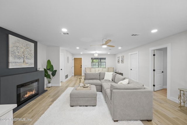 living room with ceiling fan and light hardwood / wood-style floors