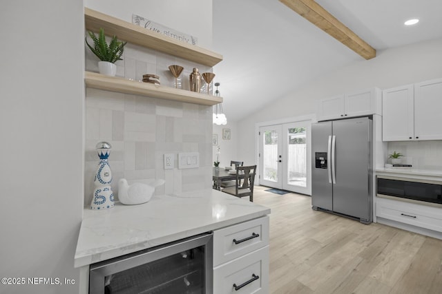 kitchen featuring tasteful backsplash, stainless steel fridge, beverage cooler, light stone countertops, and white cabinets