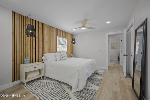 bedroom with ceiling fan and light hardwood / wood-style floors