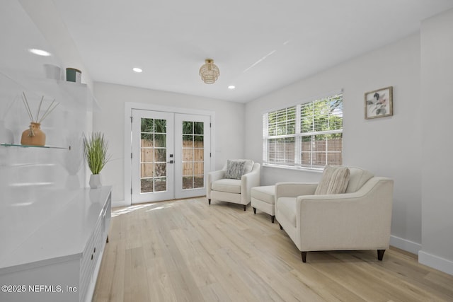 living area featuring light hardwood / wood-style floors and french doors