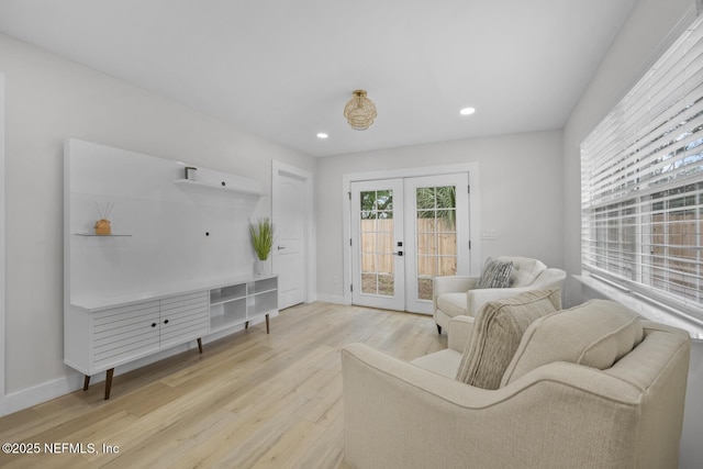 living room featuring light hardwood / wood-style floors and french doors