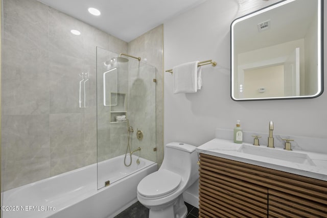 full bathroom featuring vanity, toilet, and tiled shower / bath