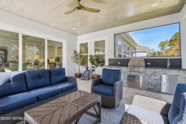 sunroom with sink, wooden ceiling, and ceiling fan