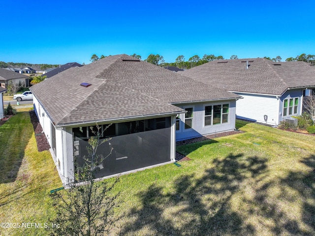 rear view of property with a yard