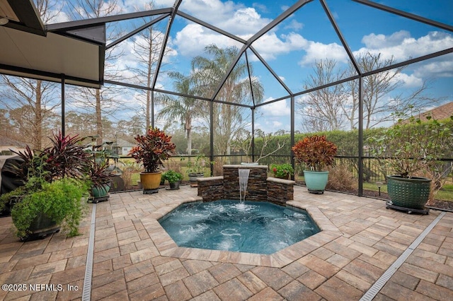 view of patio with a lanai, a jacuzzi, and pool water feature