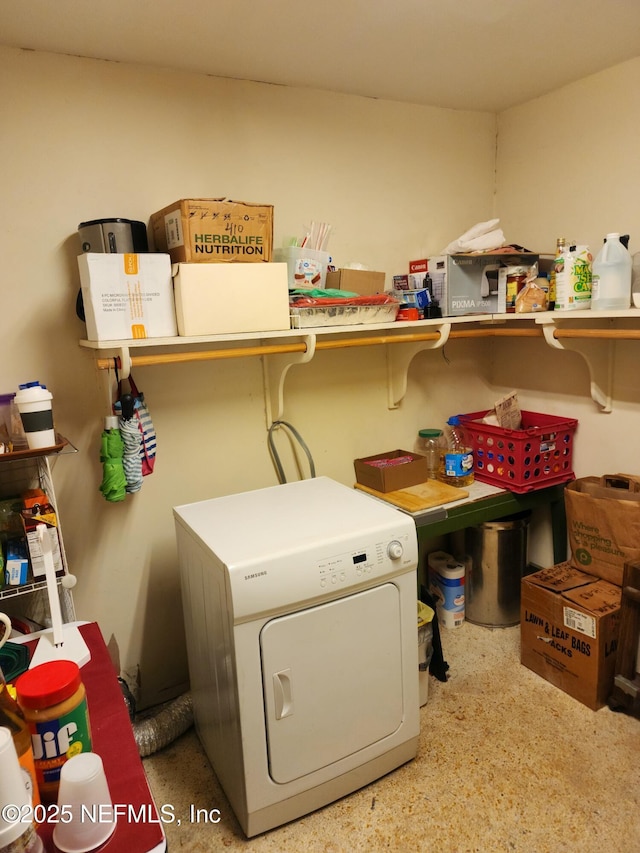 clothes washing area with washer / dryer