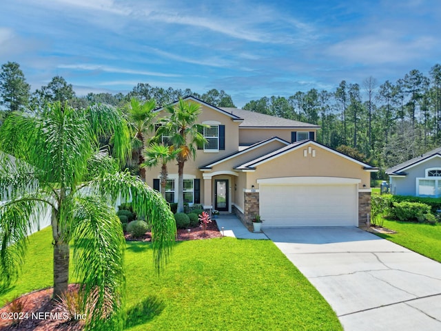 view of front of home with a garage, concrete driveway, a front yard, and stucco siding