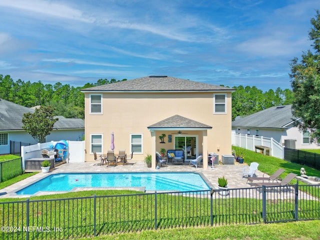 view of swimming pool featuring a fenced in pool, a yard, a patio area, ceiling fan, and a fenced backyard