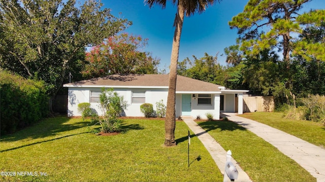 single story home featuring a front lawn