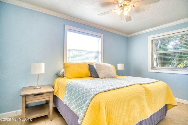 tiled bedroom with ceiling fan and ornamental molding