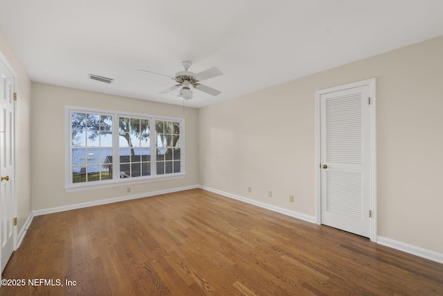 spare room with hardwood / wood-style flooring and ceiling fan