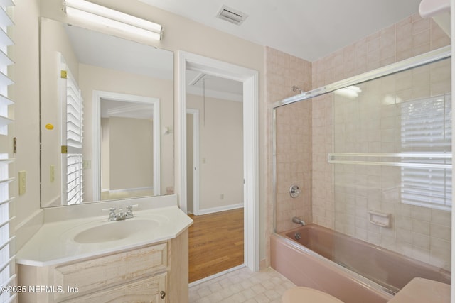 full bathroom with tiled shower / bath combo, vanity, and toilet