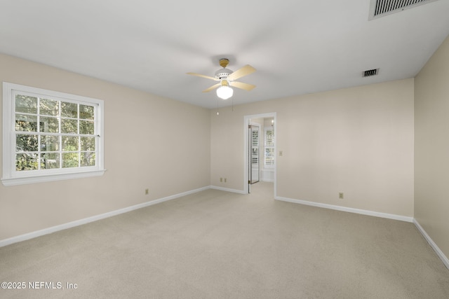 unfurnished room with ceiling fan and light carpet