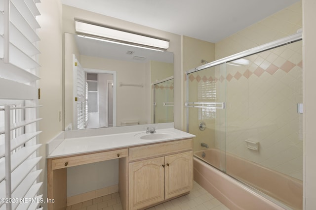 full bathroom featuring vanity, tile patterned floors, shower / bath combination with glass door, and toilet