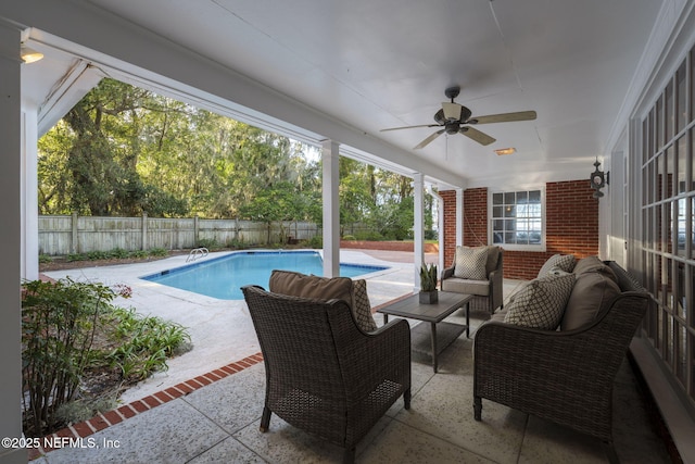 view of pool featuring outdoor lounge area, a patio, and ceiling fan