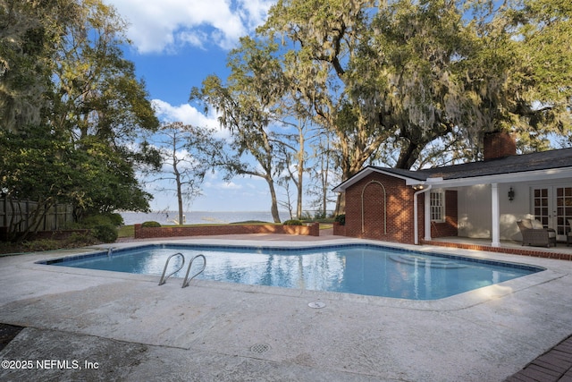 view of swimming pool with a patio area