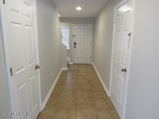 hall featuring light tile patterned floors