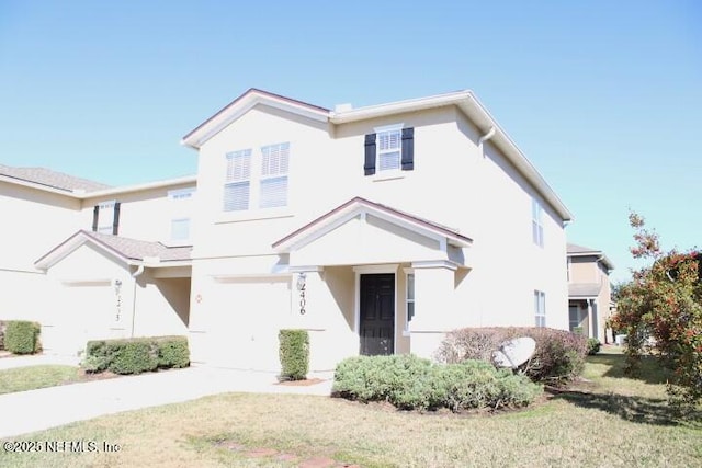 view of front of house featuring a garage and a front yard