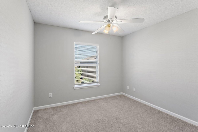 carpeted empty room with ceiling fan and a textured ceiling