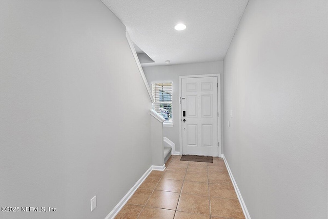 doorway to outside with light tile patterned floors