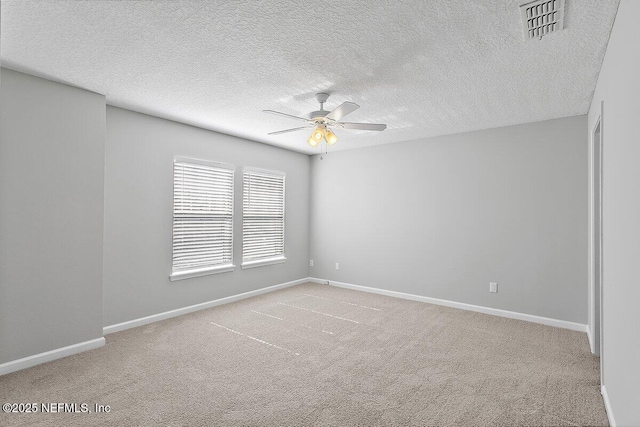 carpeted empty room with a textured ceiling and ceiling fan