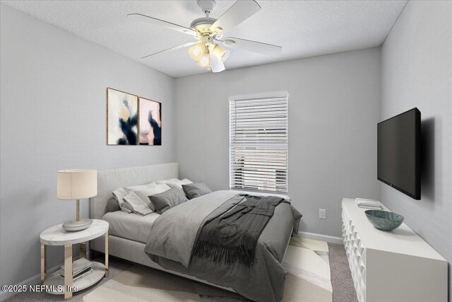1500 Calming Water Dr Unit 2406, Fleming Island, FL 32003 - bedroom featuring baseboards, ceiling fan, and a textured ceiling