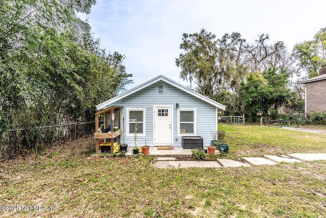 rear view of property with a yard