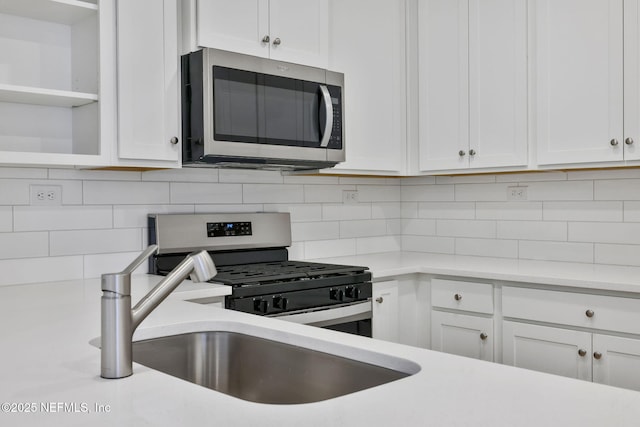 kitchen featuring white cabinetry, appliances with stainless steel finishes, and backsplash